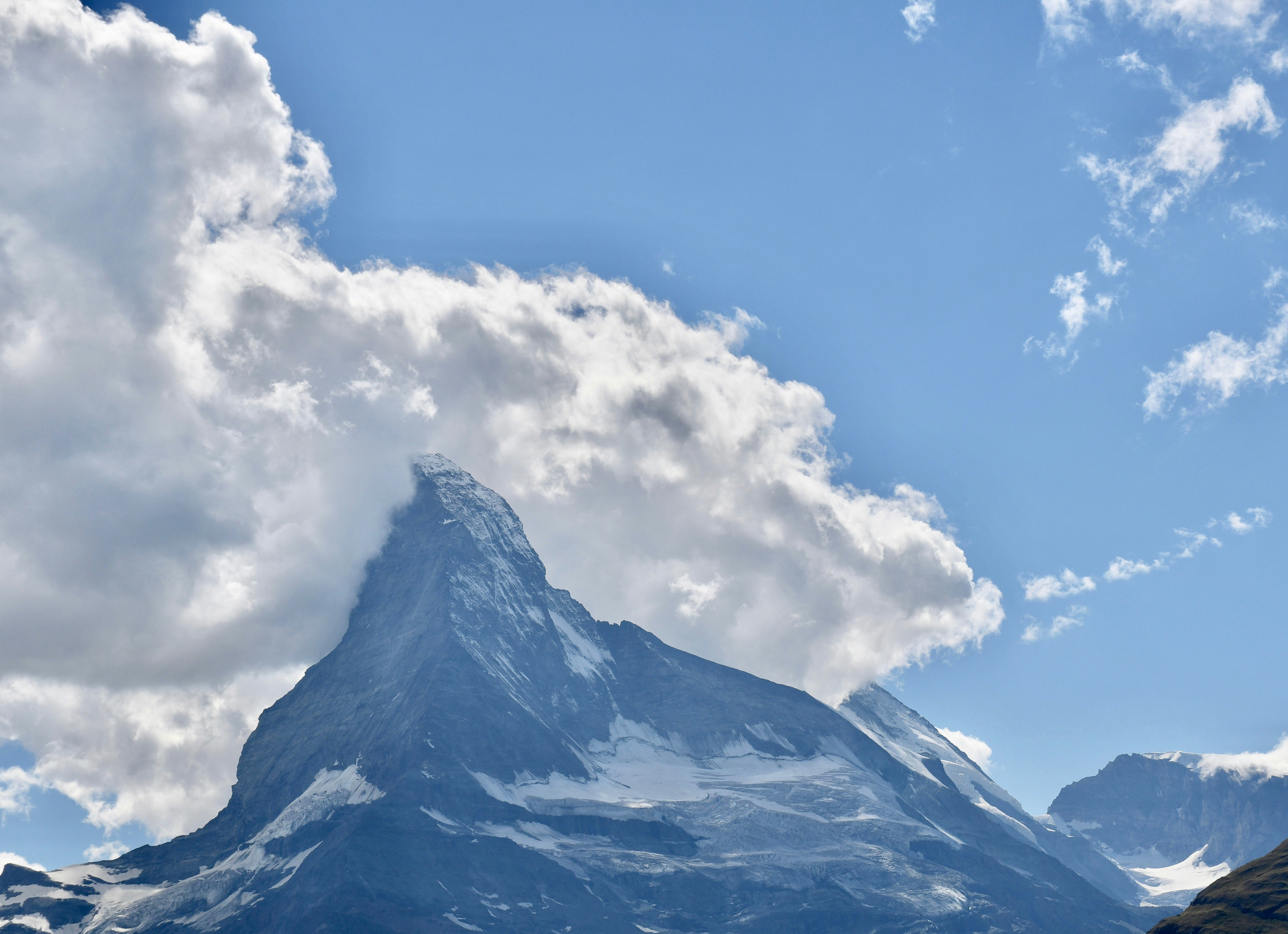 snow covered mountain under blue sky during daytime